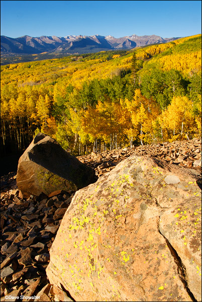 Boulders provide a lead-in to golden aspen trees and the distant Castle formation on Ohio Pass one autumn morning.&nbsp;